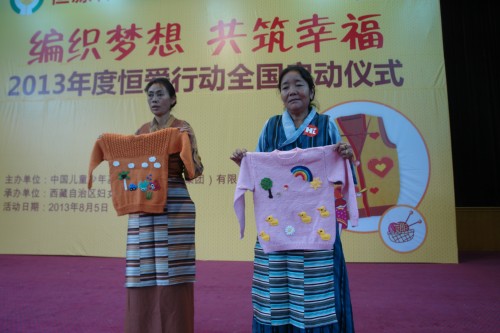The 2013 Heng'ai Action to provide orphans and disabled children with free knitted sweaters is launched on August 5, 2013, in Lhasa, capital city of southwest China's Tibet Autonomous Region. [Tibet Women's Federation / Zhang Hongping]