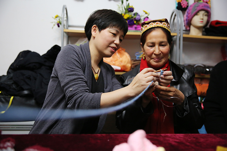 内地家庭与新疆家庭共织爱心毛衣。中国儿童少年基金会供图。.JPG